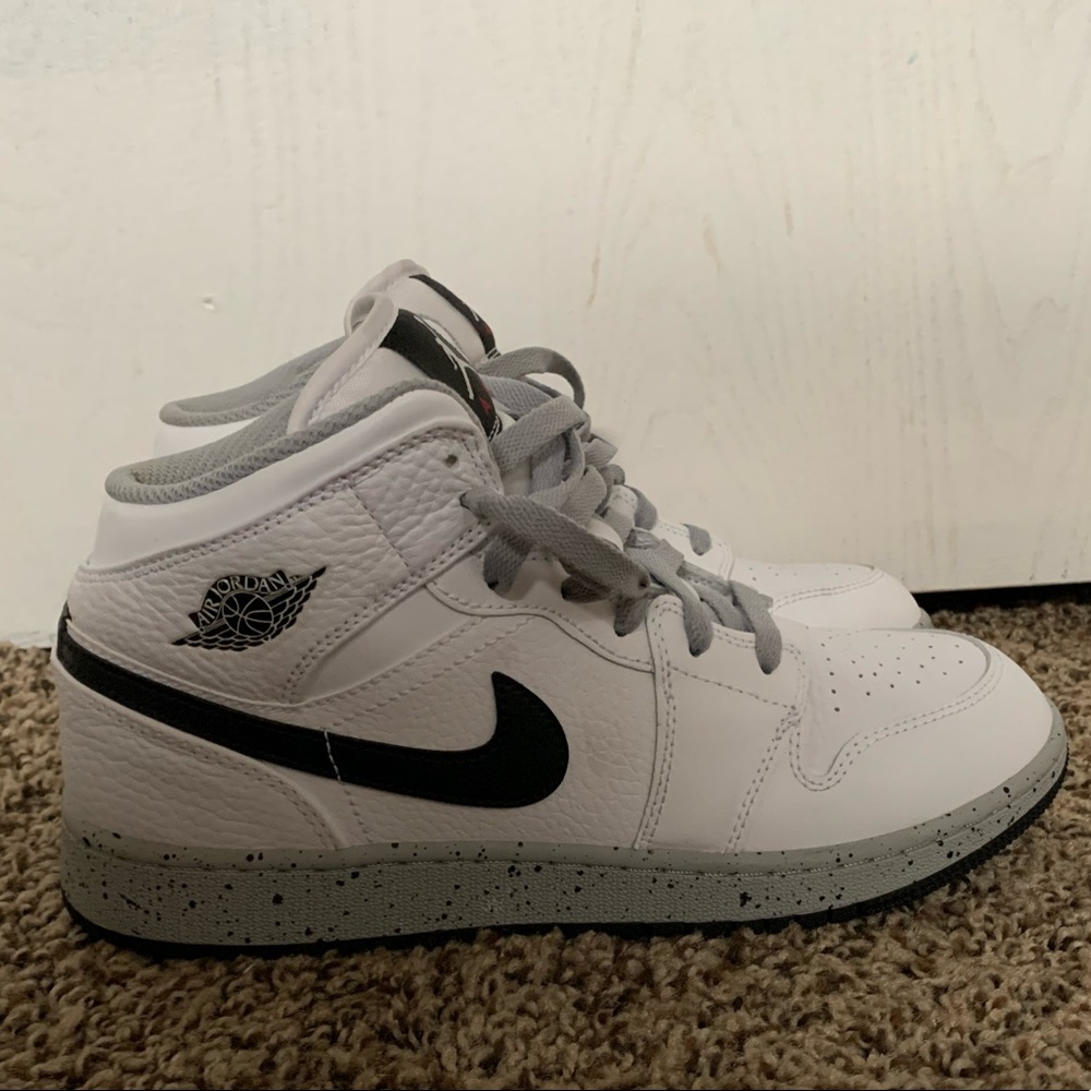 Gray and white mid top Jordan 1